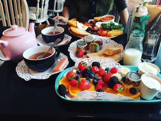 Spread of breakfast foods and tea.